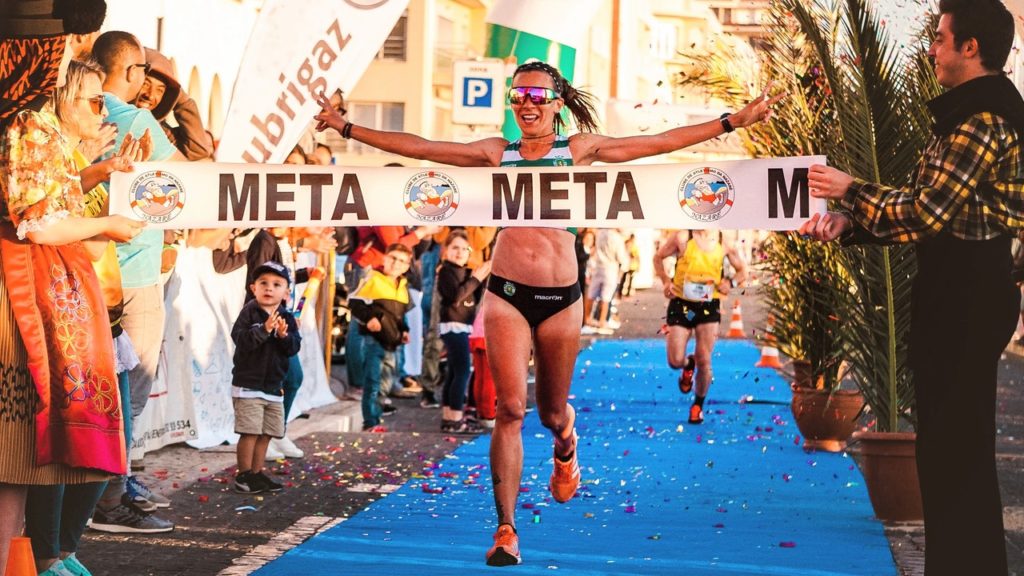 Photo of a woman reaching the finish line of a marathon.