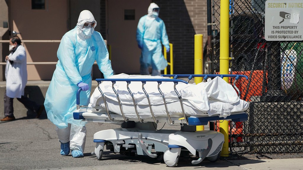 Bodies are moved to a refrigeration truck serving as a temporary morgue at Wyckoff Hospital in the Borough of Brooklyn on April 6, 2020 in New York.