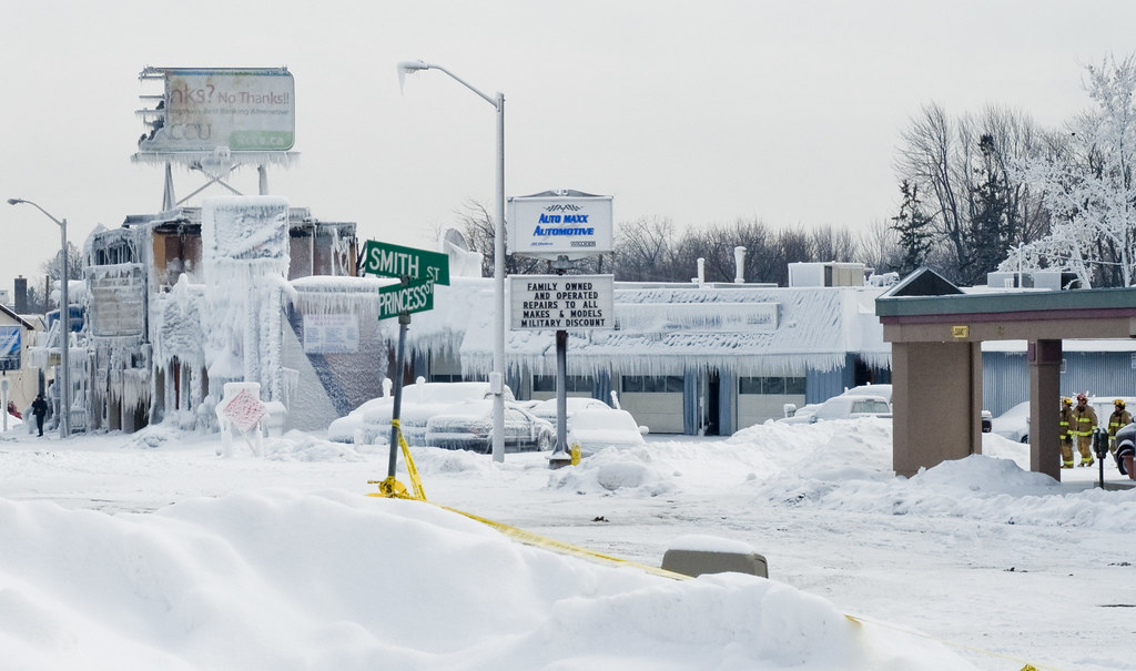 Image of roads and buildings covered with snow. 