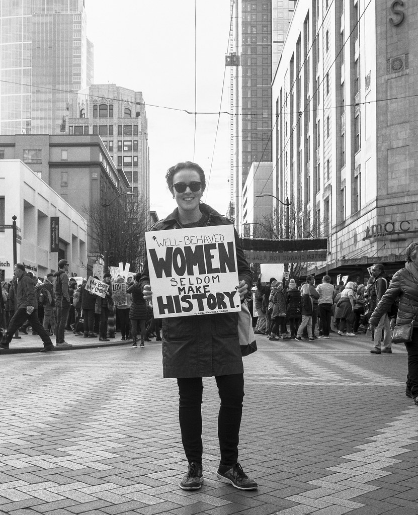 A woman holding a placard.